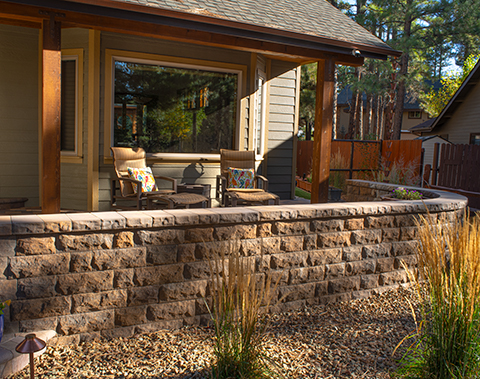 Belgard rustic wallblocks has a short privacy porch fence.