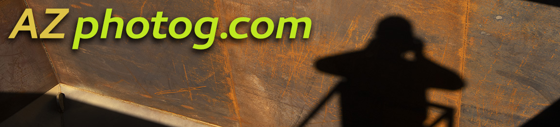 Photographer's shadow against weathered steel hopper wall 